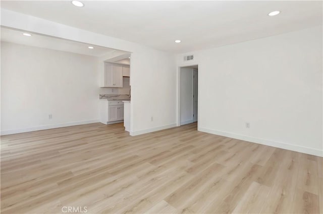 31278 Calle San Juan Unit 12F, San Juan Capistrano, CA 92675 - unfurnished living room with light wood finished floors, recessed lighting, and baseboards