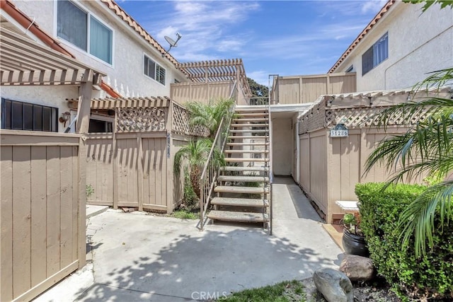 31278 Calle San Juan Unit 12F, San Juan Capistrano, CA 92675 - fenced backyard featuring a patio, stairway, and a pergola