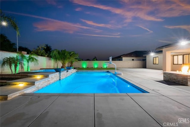 12312 Ashlyn Dr, Bakersfield, CA 93311 - view of swimming pool with an in-ground hot tub, a fenced backyard, a patio, and an outdoor fire pit