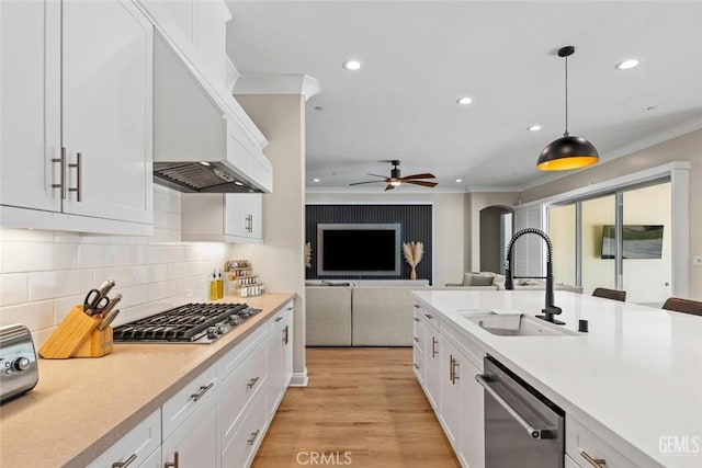 12312 Ashlyn Dr, Bakersfield, CA 93311 - kitchen with stainless steel appliances, a sink, crown molding, recessed lighting, and custom range hood
