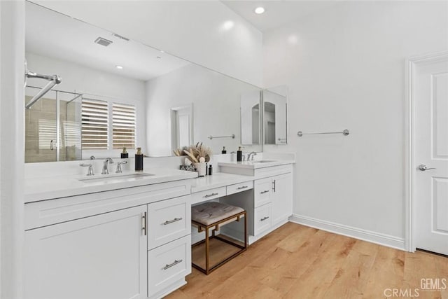 12312 Ashlyn Dr, Bakersfield, CA 93311 - full bath featuring double vanity, a stall shower, wood finished floors, recessed lighting, and baseboards
