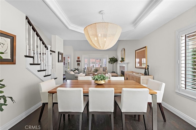 23982 Cormorant Ln, Laguna Niguel, CA 92677 - dining space featuring dark wood-style floors, healthy amount of natural light, a tray ceiling, and crown molding
