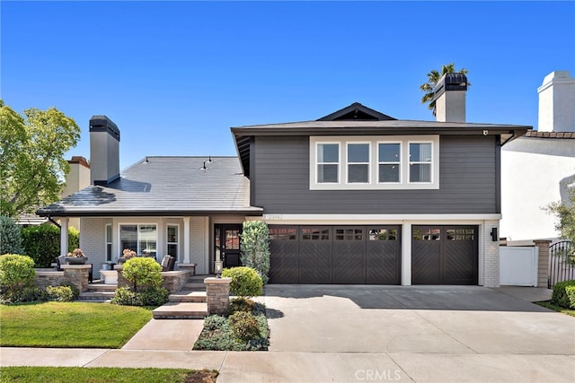 23982 Cormorant Ln, Laguna Niguel, CA 92677 - view of front of home featuring an attached garage, concrete driveway, a chimney, and brick siding