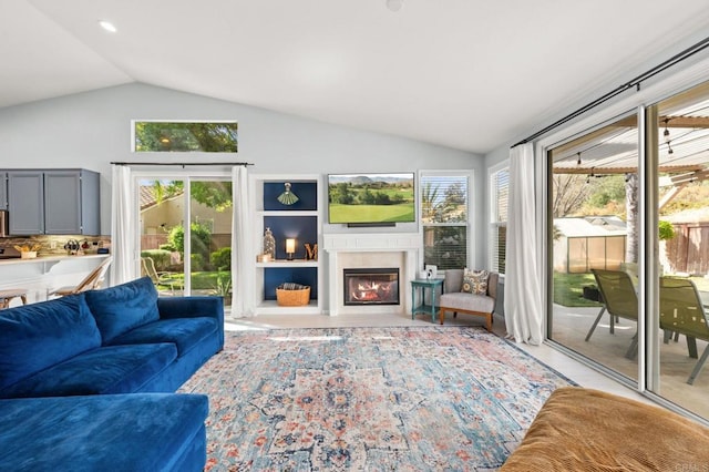 3374 Avocado Vista Ln, Fallbrook, CA 92028 - living room with lofted ceiling, healthy amount of natural light, and a glass covered fireplace