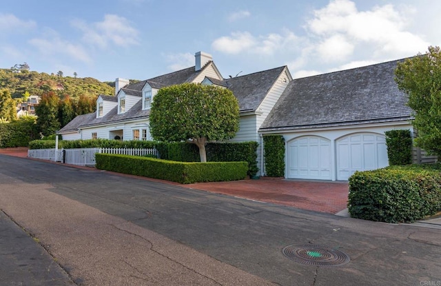 7716 Lookout Dr, La Jolla, CA 92037 - view of front of home with decorative driveway and a chimney