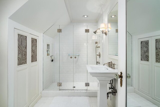 7716 Lookout Dr, La Jolla, CA 92037 - bathroom featuring a stall shower, crown molding, marble look tiles, recessed lighting, and a sink