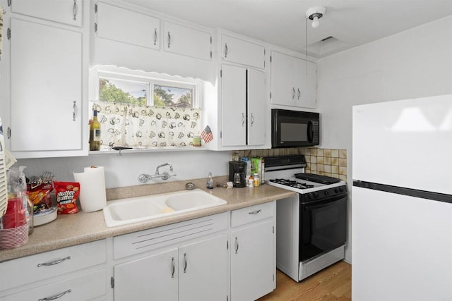321 E Meda Ave, Glendora, CA 91741 - kitchen with freestanding refrigerator, range with gas cooktop, black microwave, a sink, and white cabinets