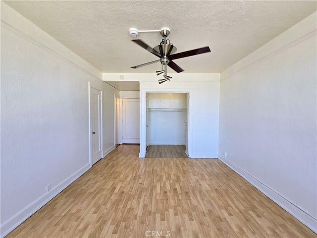 455 E Ocean Blvd Unit 715, Long Beach, CA 90802 - unfurnished bedroom featuring light wood-style flooring, a textured ceiling, and a ceiling fan