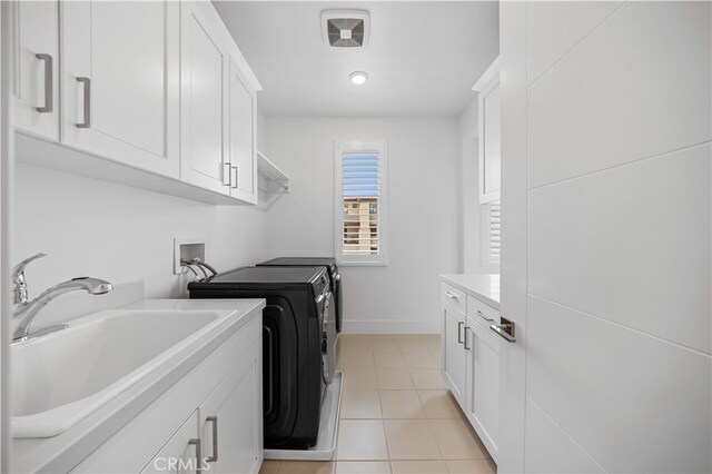 72 Crater, Irvine, CA 92618 - laundry area featuring independent washer and dryer, light tile patterned floors, cabinet space, and baseboards