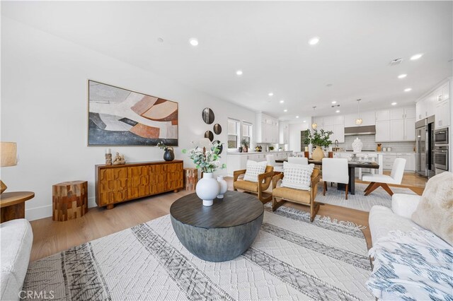 72 Crater, Irvine, CA 92618 - living room featuring recessed lighting, light wood finished floors, and baseboards