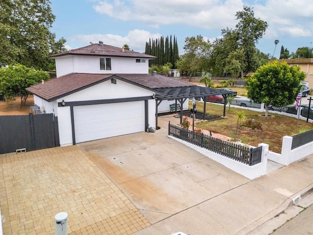1220 Hoover St, Escondido, CA 92027 - view of front facade featuring stucco siding, an attached garage, and driveway