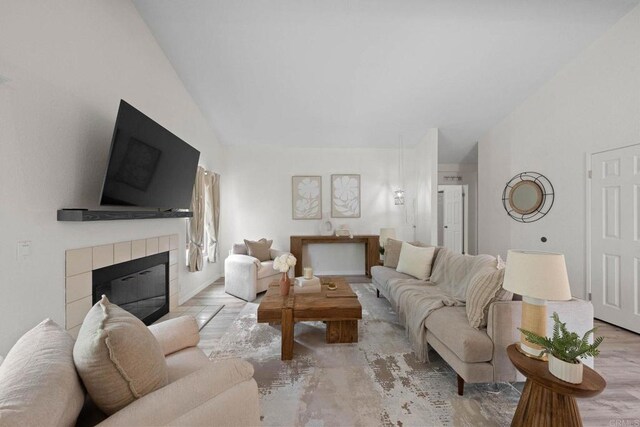 4938 Dulin Rd, Fallbrook, CA 92028 - living room featuring lofted ceiling, a tiled fireplace, and wood finished floors