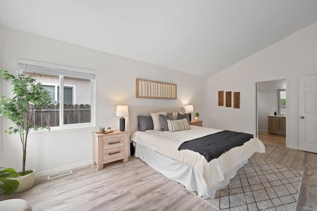 4938 Dulin Rd, Fallbrook, CA 92028 - bedroom with light wood-type flooring, lofted ceiling, and connected bathroom