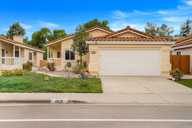 4938 Dulin Rd, Fallbrook, CA 92028 - mediterranean / spanish house featuring concrete driveway, stucco siding, an attached garage, and a tiled roof