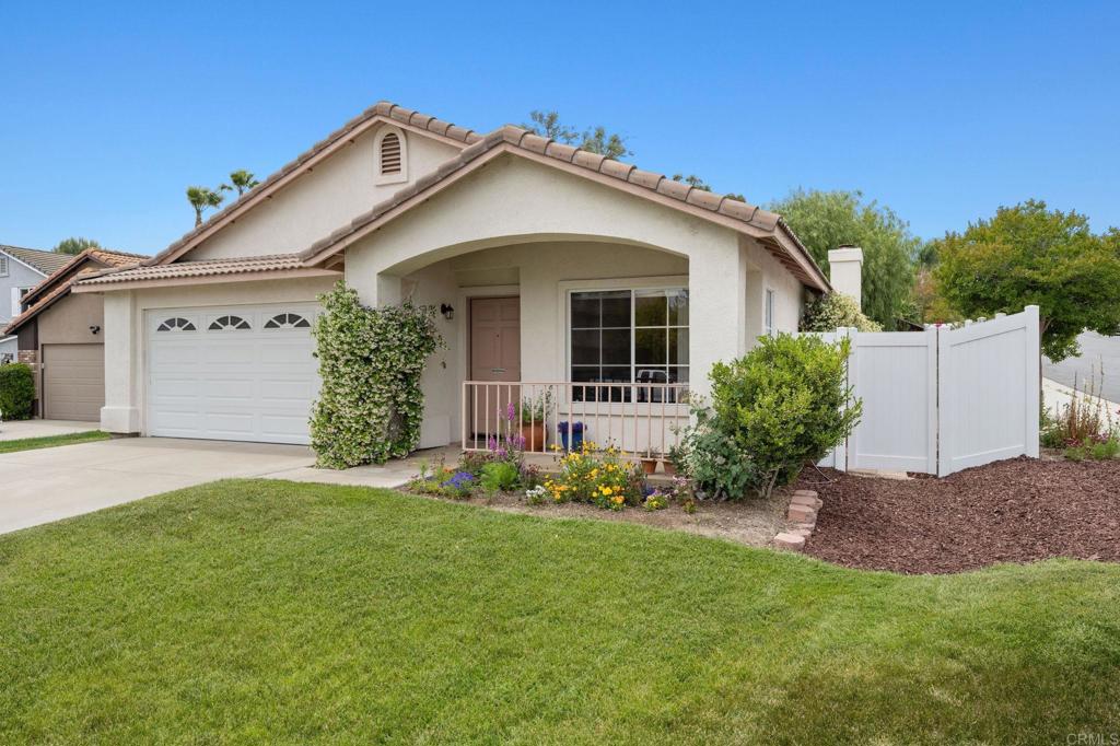 43765 Corte Amaya, Temecula, CA 92592 - view of front of home with a garage, driveway, stucco siding, a porch, and a tiled roof
