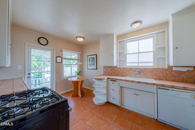 1736 Craig Ave, Altadena, CA 91001 - kitchen with white dishwasher, black range with gas stovetop, decorative backsplash, and white cabinetry