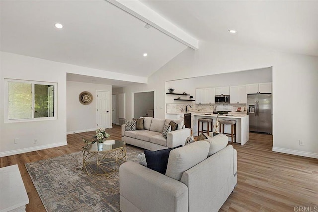 1208 Via Viento Suave, San Marcos, CA 92078 - living room featuring beamed ceiling, baseboards, light wood-style floors, recessed lighting, and high vaulted ceiling