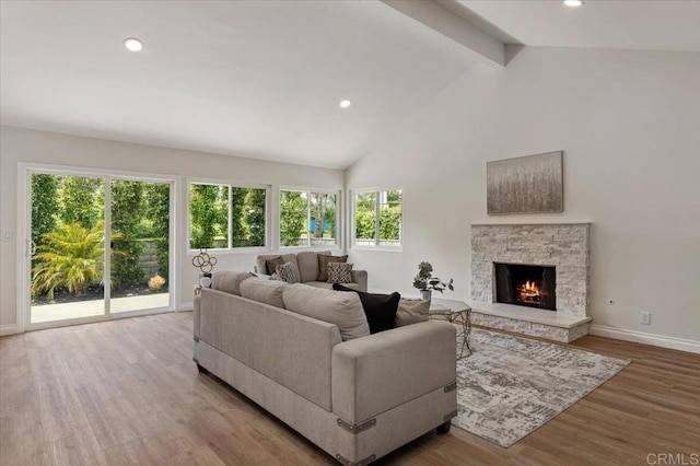 1208 Via Viento Suave, San Marcos, CA 92078 - living area featuring plenty of natural light, beam ceiling, wood finished floors, baseboards, and a fireplace