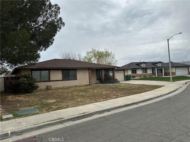37824 Queensboro Ct, Palmdale, CA 93552 - view of front of property with a garage, driveway, a chimney, stucco siding, and a front yard