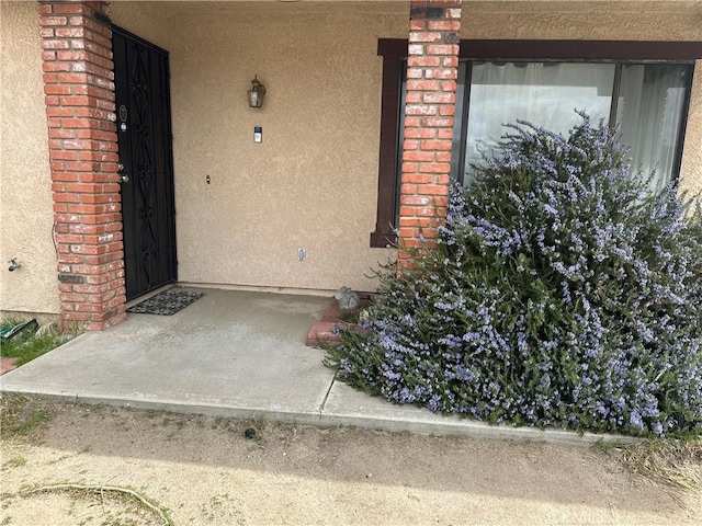 37824 Queensboro Ct, Palmdale, CA 93552 - doorway to property featuring stucco siding and brick siding
