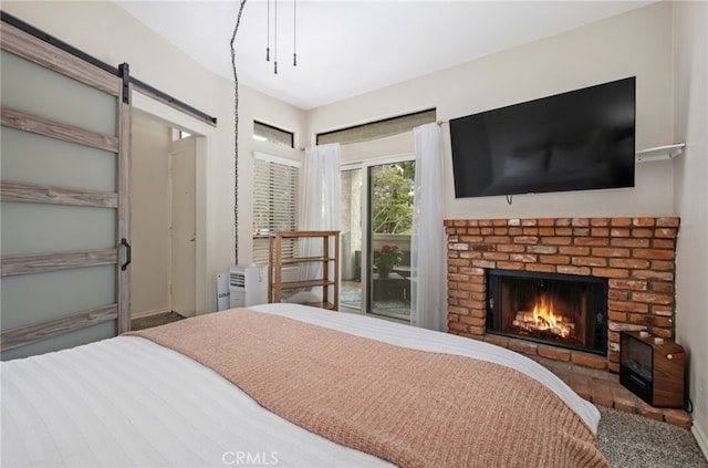 17191 Corbina Ln Unit 109, Huntington Beach, CA 92649 - bedroom featuring access to outside, a fireplace, a barn door, and carpet
