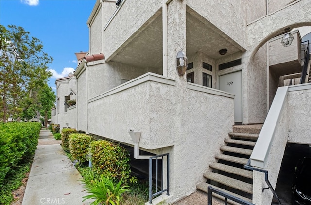 17191 Corbina Ln Unit 109, Huntington Beach, CA 92649 - view of side of property with stairway and stucco siding