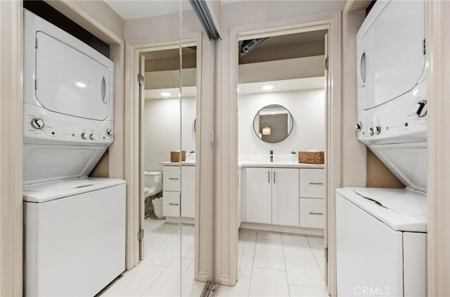 17191 Corbina Ln Unit 109, Huntington Beach, CA 92649 - laundry room featuring stacked washer / drying machine and light marble finish floors