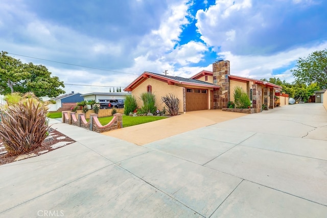 2818 W 166th St, Torrance, CA 90504 - view of front facade with concrete driveway, an attached garage, stucco siding, stone siding, and a front lawn