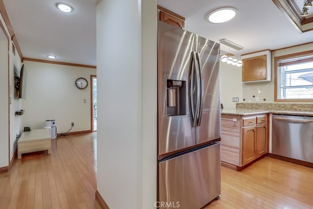 2818 W 166th St, Torrance, CA 90504 - kitchen with stainless steel appliances, crown molding, light wood-style floors, light stone countertops, and brown cabinetry