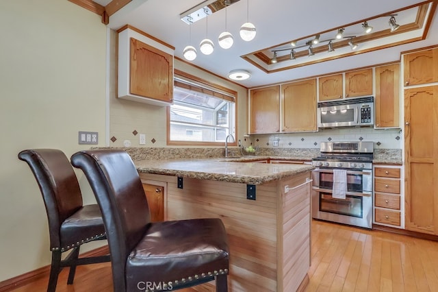 2818 W 166th St, Torrance, CA 90504 - kitchen featuring appliances with stainless steel finishes, backsplash, light wood finished floors, and crown molding