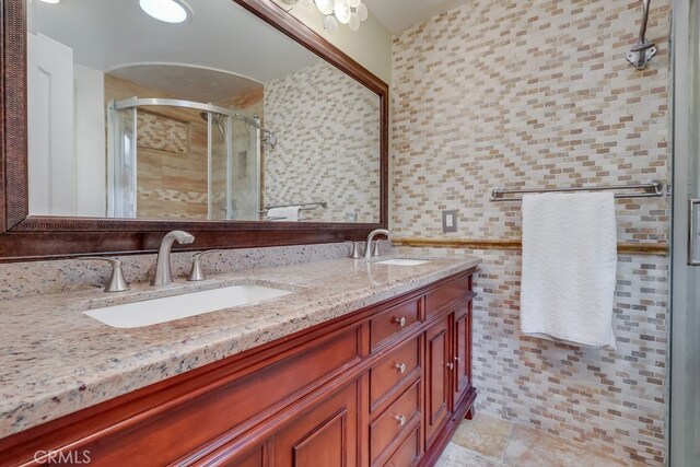 2818 W 166th St, Torrance, CA 90504 - bathroom with double vanity, a stall shower, and tile walls