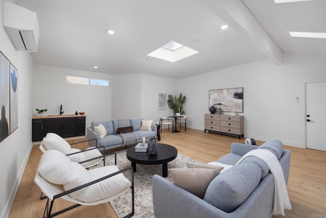 3852 Bledsoe Ave, Los Angeles, CA 90066 - living room with a skylight, a wall unit AC, light wood-style flooring, recessed lighting, and baseboards