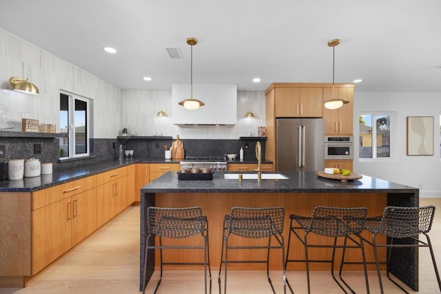 3852 Bledsoe Ave, Los Angeles, CA 90066 - kitchen with stainless steel appliances, a sink, decorative backsplash, a kitchen breakfast bar, and hanging light fixtures