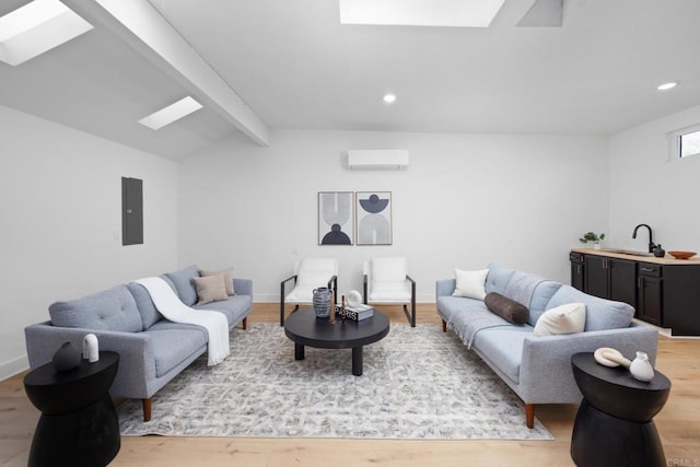 3852 Bledsoe Ave, Los Angeles, CA 90066 - living room with a skylight, light wood-style flooring, recessed lighting, an AC wall unit, and electric panel
