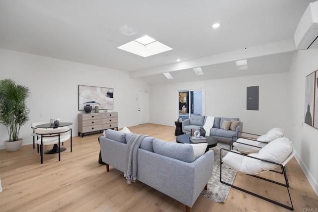 3852 Bledsoe Ave, Los Angeles, CA 90066 - living room with a skylight, vaulted ceiling, a wall mounted air conditioner, light wood finished floors, and electric panel