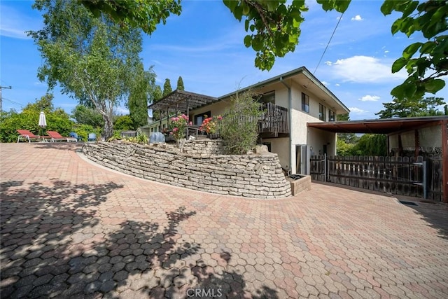 6058 Joan Pl, San Luis Obispo, CA 93401 - view of property exterior featuring stucco siding and a balcony