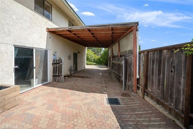 6058 Joan Pl, San Luis Obispo, CA 93401 - view of patio featuring a carport and an exterior structure