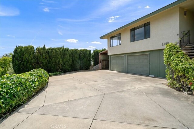 6058 Joan Pl, San Luis Obispo, CA 93401 - view of side of home with a garage, concrete driveway, and stucco siding
