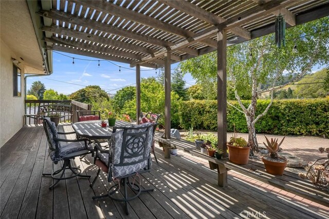 6058 Joan Pl, San Luis Obispo, CA 93401 - wooden deck with a pergola, outdoor dining area, and view of scattered trees