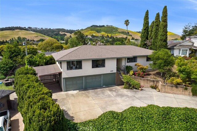 6058 Joan Pl, San Luis Obispo, CA 93401 - view of front of property featuring a garage, concrete driveway, stucco siding, stairs, and a mountain view