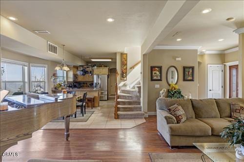 26941 Stirrup Way, Tehachapi, CA 93561 - living room featuring stairway, ornamental molding, light wood-style floors, baseboards, and recessed lighting