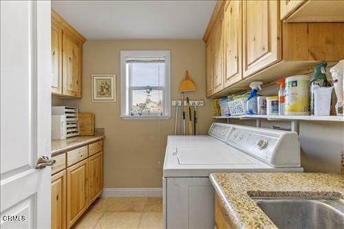26941 Stirrup Way, Tehachapi, CA 93561 - laundry room with washer and clothes dryer, baseboards, light tile patterned floors, and cabinet space