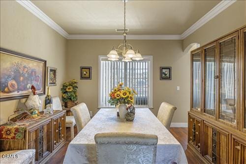 26941 Stirrup Way, Tehachapi, CA 93561 - dining space featuring dark wood finished floors, crown molding, a chandelier, and baseboards