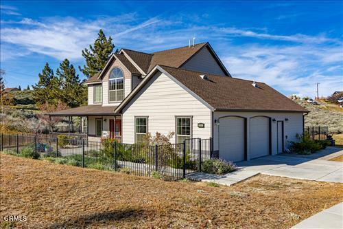26941 Stirrup Way, Tehachapi, CA 93561 - view of front of home featuring concrete driveway, an attached garage, and a porch