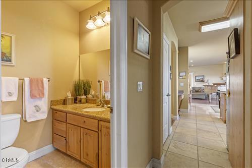 26941 Stirrup Way, Tehachapi, CA 93561 - bathroom with toilet, vanity, tile patterned flooring, and baseboards