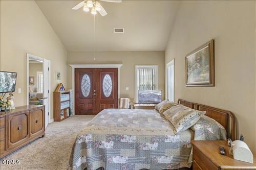 26941 Stirrup Way, Tehachapi, CA 93561 - bedroom with light carpet, high vaulted ceiling, and ceiling fan
