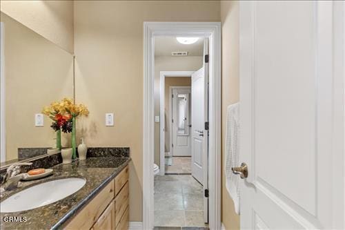 26941 Stirrup Way, Tehachapi, CA 93561 - bathroom featuring vanity, toilet, tile patterned floors, and baseboards