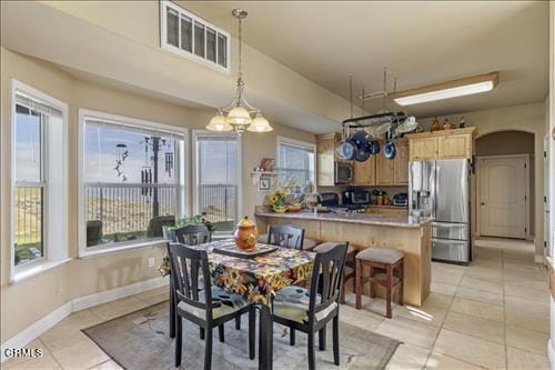 26941 Stirrup Way, Tehachapi, CA 93561 - dining room with light tile patterned floors, baseboards, and arched walkways