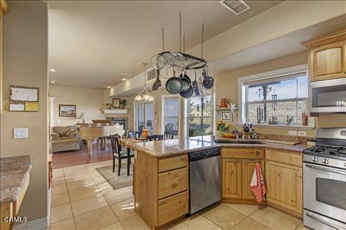 26941 Stirrup Way, Tehachapi, CA 93561 - kitchen with stainless steel appliances, light brown cabinetry, and light tile patterned flooring