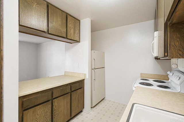 5700 Baltimore Dr Unit 134, La Mesa, CA 91942 - kitchen with white appliances, light floors, light countertops, and a sink
